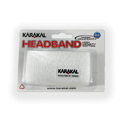 A white Karakal headband made from cotton, packaged in a clear plastic blister pack with the brand name and logo visible on the top.